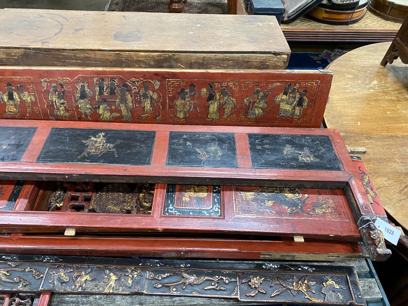 Nine sections of a Chinese red lacquered cabinet, with gilt figural decoration